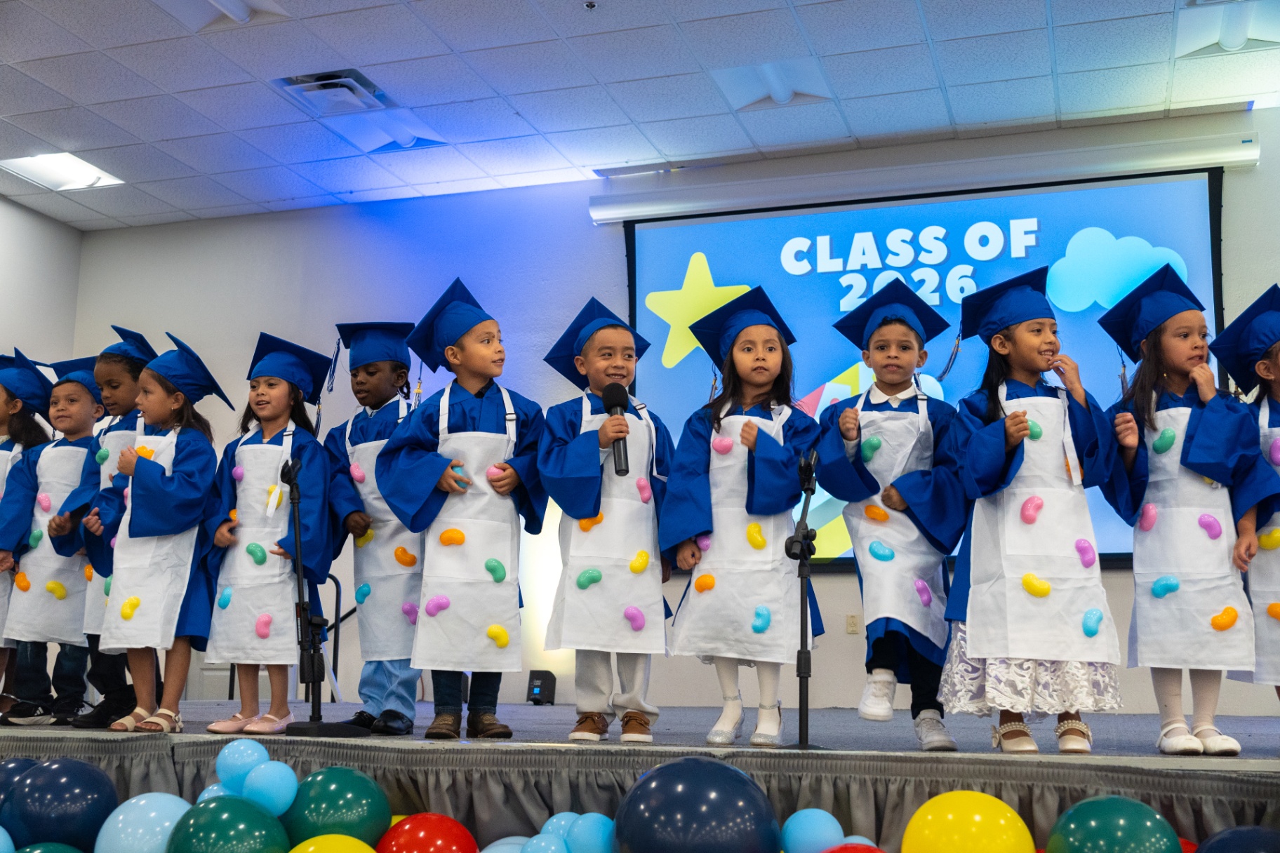 VPK students performing in caps and aprons