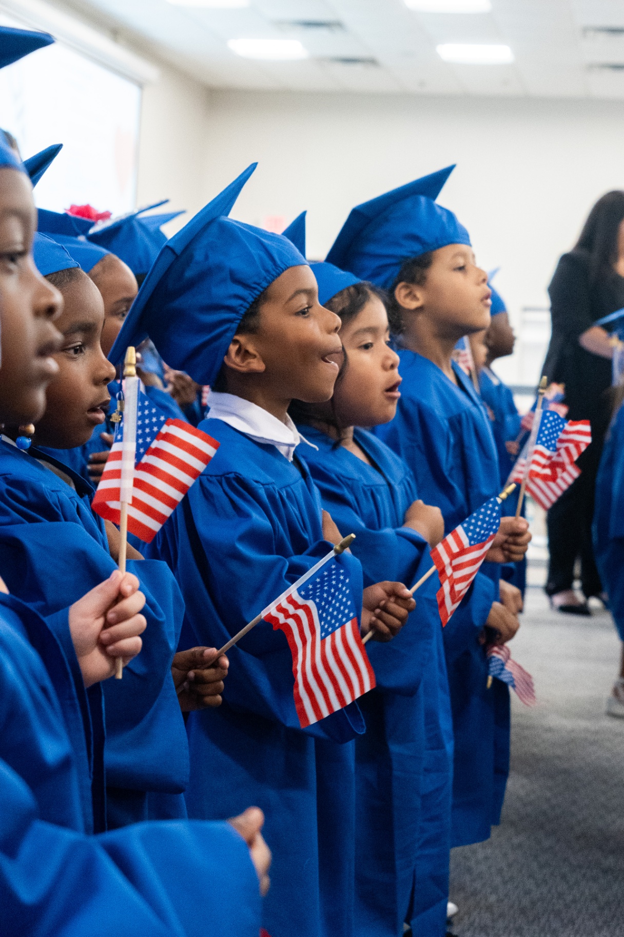 VPK graduates holding American flags
