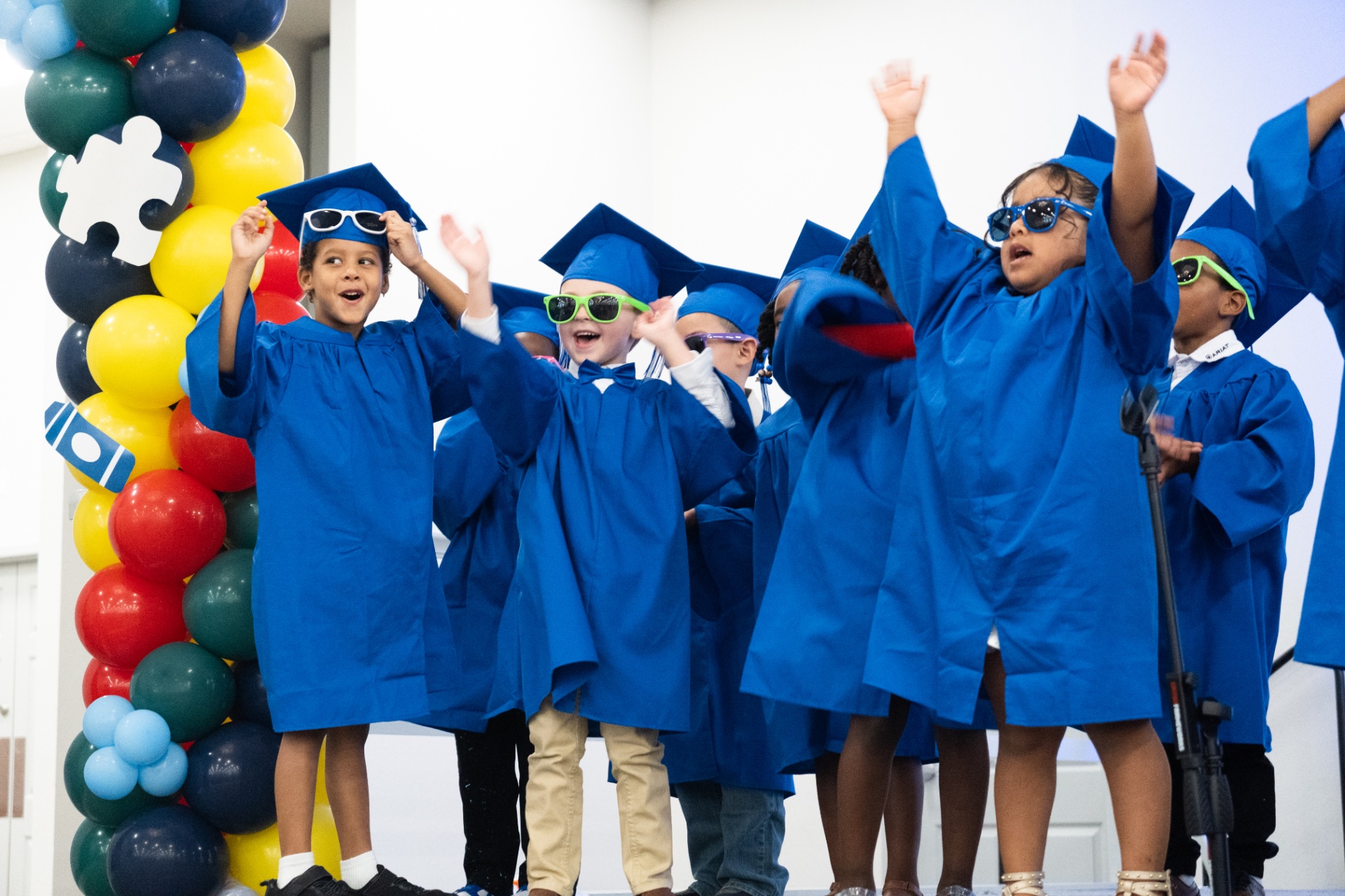 VPK graduates cheering with sunglasses and caps